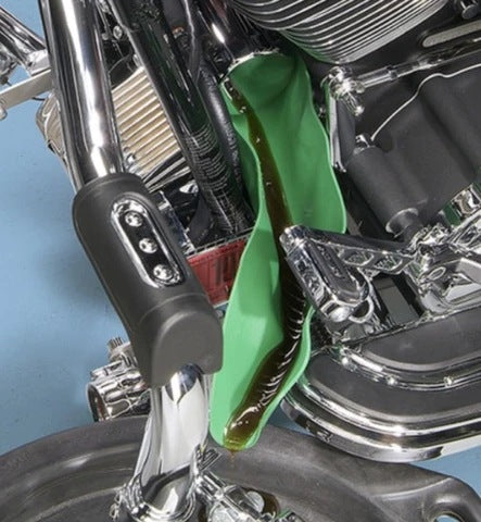 Green flexible funnel draining fluid from a motorcycle engine