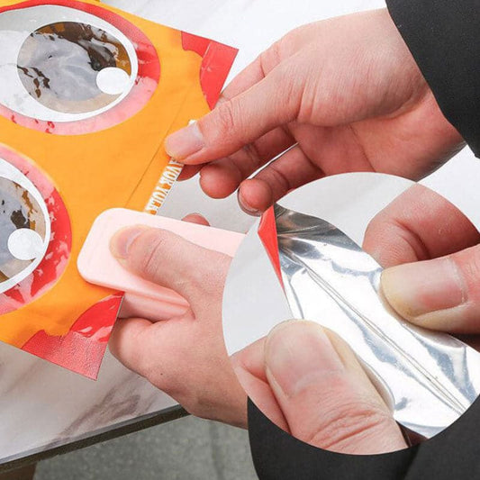 Person sealing a bag of chips with a small kitchen tool