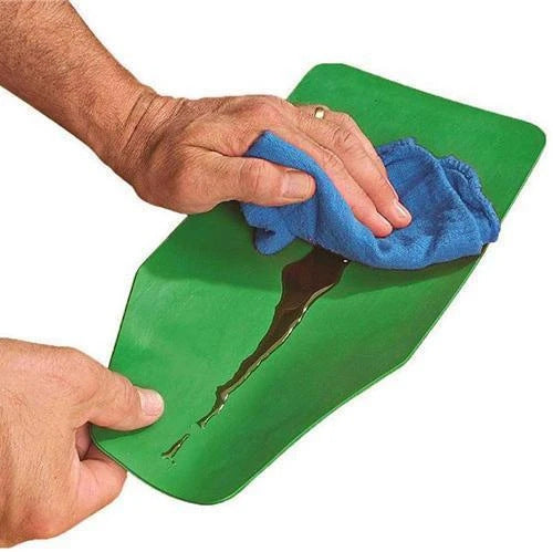Wiping the green silicone flexible funnel clean with a blue cloth