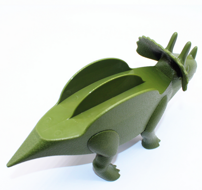 Back view of a green dinosaur taco holder showing the taco slots