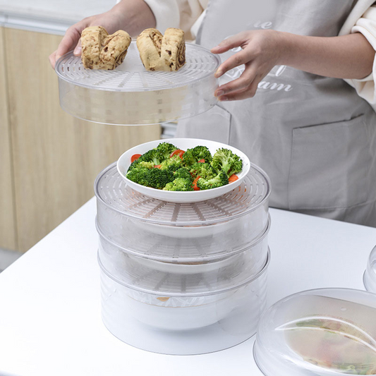 Person placing the top dome cover onto the stacked food trays