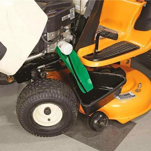 Green flexible silicone funnel draining fluid from a lawnmower