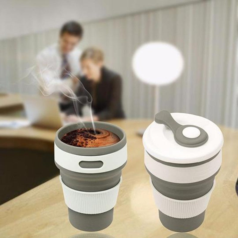 Grey collapsible silicone travel cup on a table