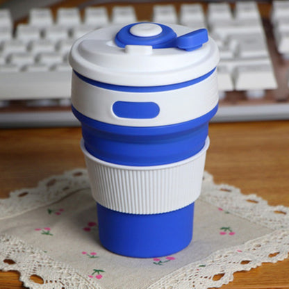 Blue collapsible silicone travel cup on a desk