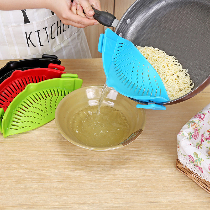 Blue clip-on strainer draining noodles from a pan