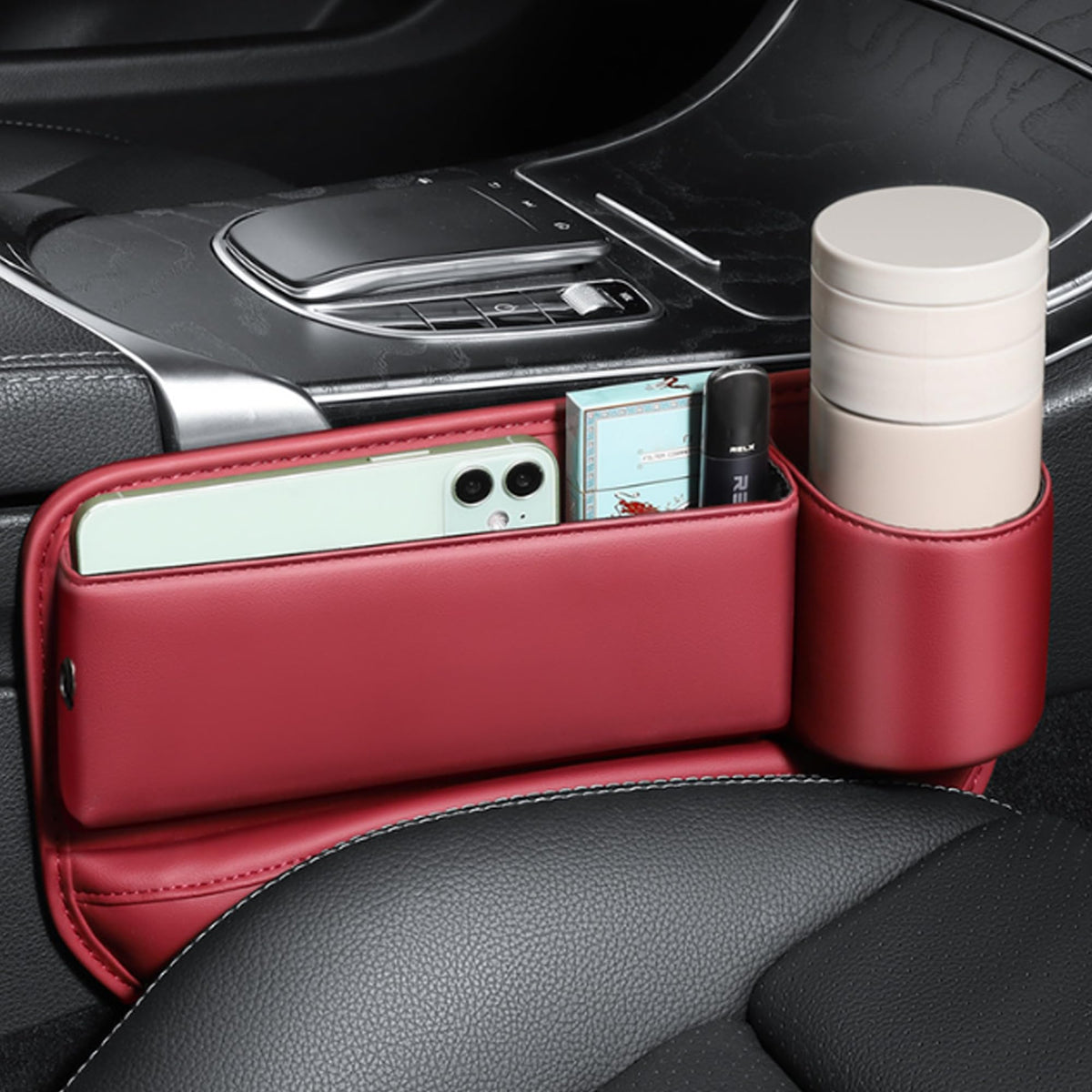Red gap filler organizer holding a phone in a car