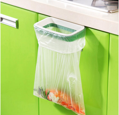 Trash bag holder hanging on a cabinet door