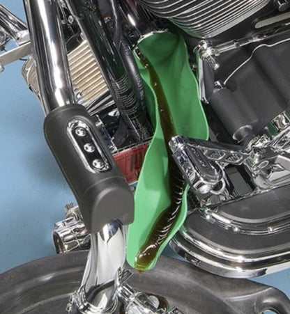 Green flexible funnel draining fluid from a motorcycle engine