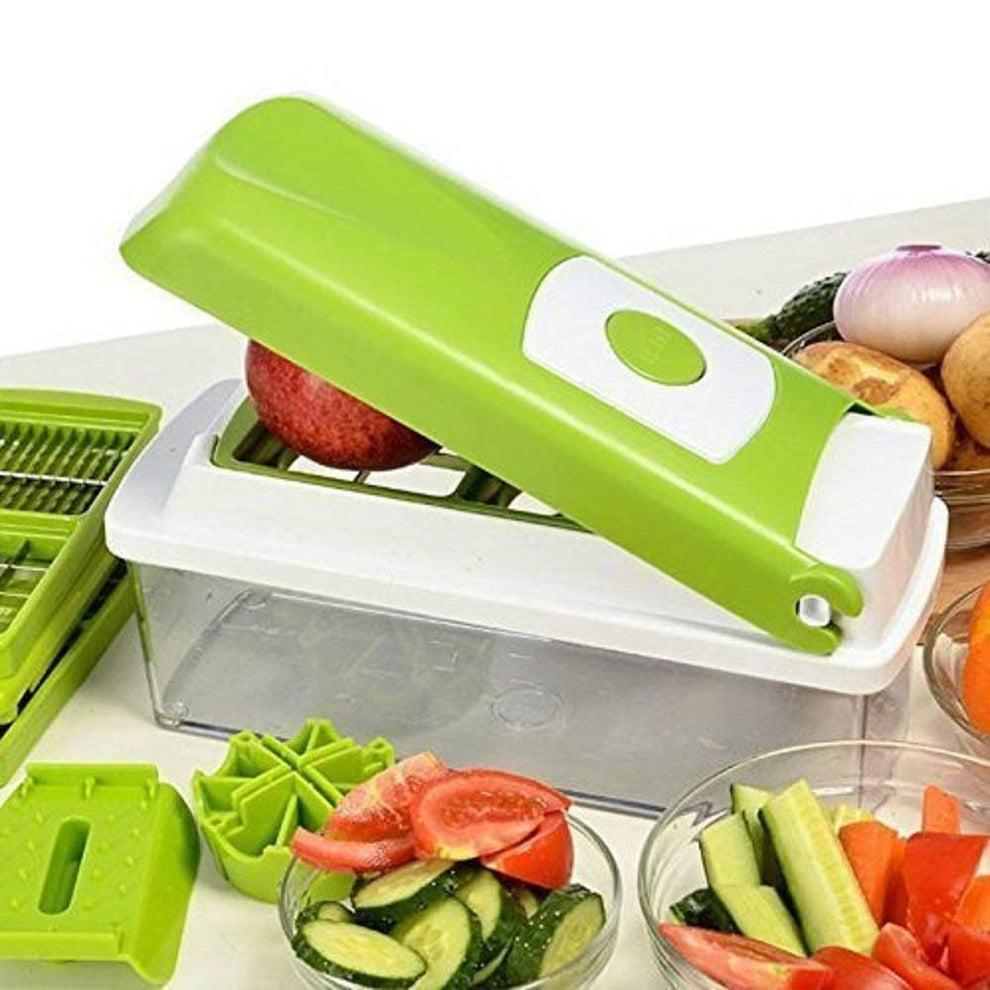 Close up of pushing an apple through the green vegetable chopper