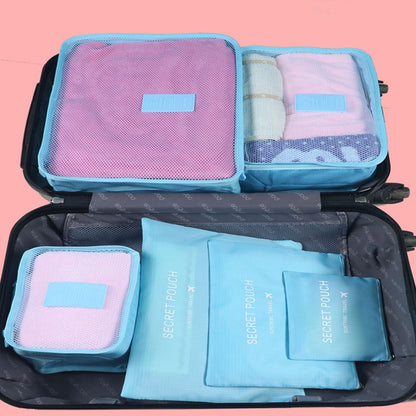 Blue travel packing cubes organized in an open suitcase