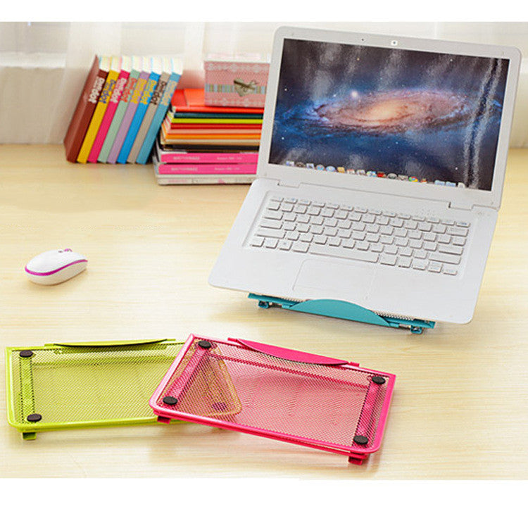 Green and pink foldable laptop stands on a desk