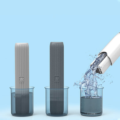 Grey and white sponge heads absorbing water from beakers