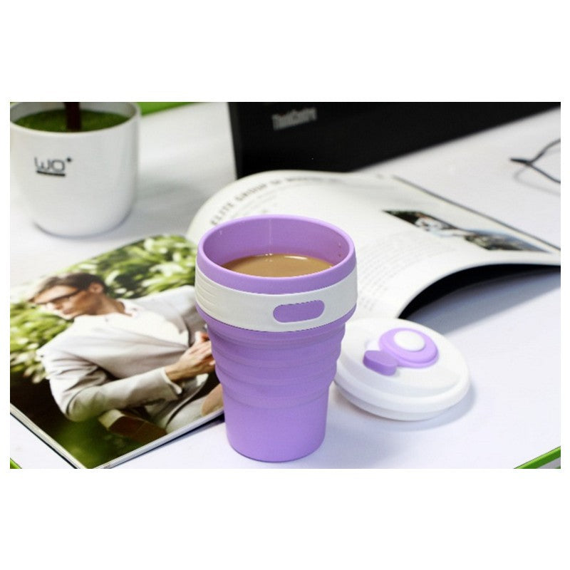Purple collapsible silicone travel cup on a desk