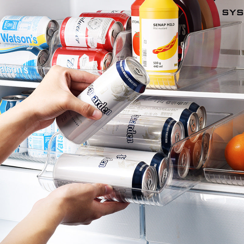 Hand taking a can from the transparent fridge can organizer dispenser