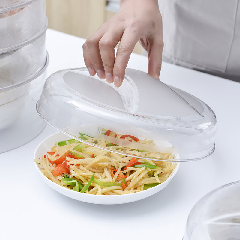 Lifting the clear plastic food dome to reveal a meal