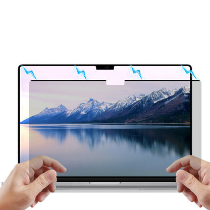 Person attaching magnetic privacy screen to laptop
