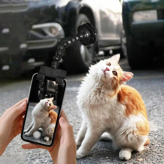 Black pet selfie clip holding a treat above a smartphone to attract a cat