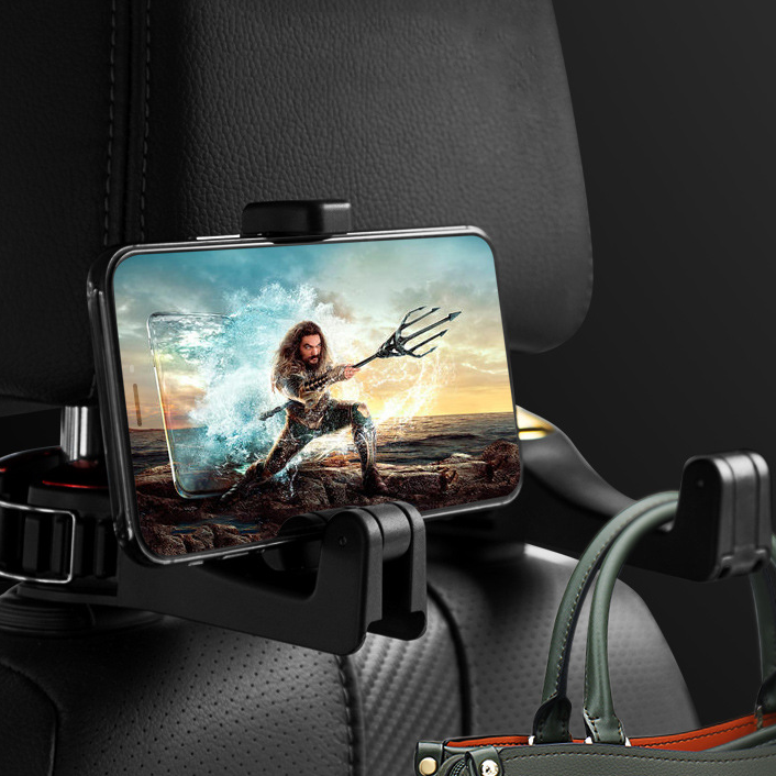 Headrest hook holding a phone playing a video and a bag