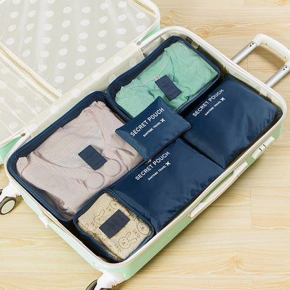 Navy blue travel packing cubes organized in an open suitcase