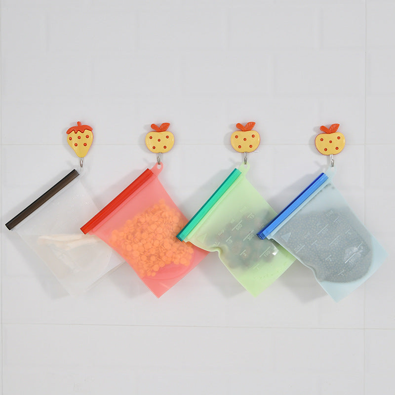 Silicone food storage bags hanging from hooks on a wall