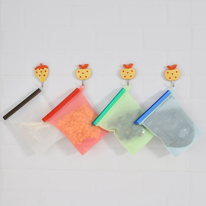 Silicone food storage bags hanging from hooks on a wall