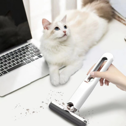 White mini squeeze mop cleaning a white desk next to a cat