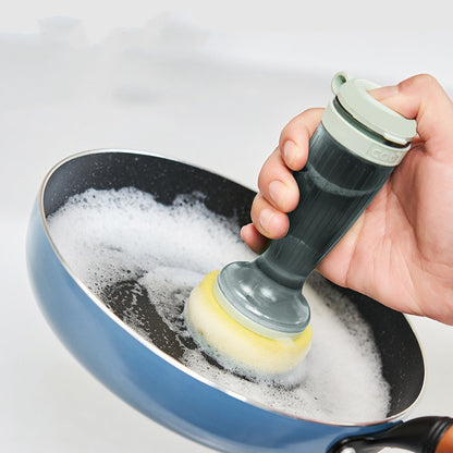 Using the dish brush with a sponge head to clean a soapy blue pan