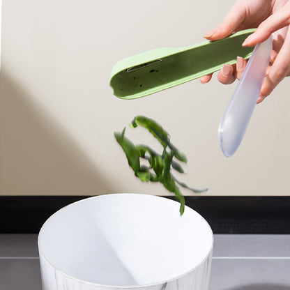 Emptying peels from the vegetable peeler storage tube into a trash can