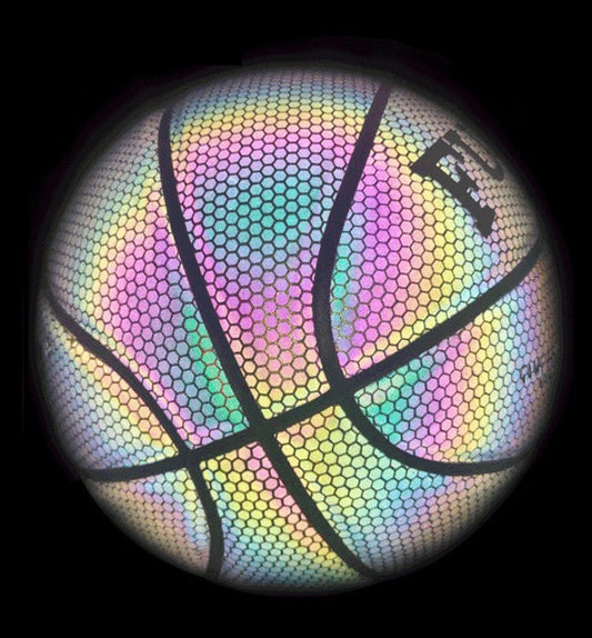 Youth size 5 reflective basketball being held by a young player