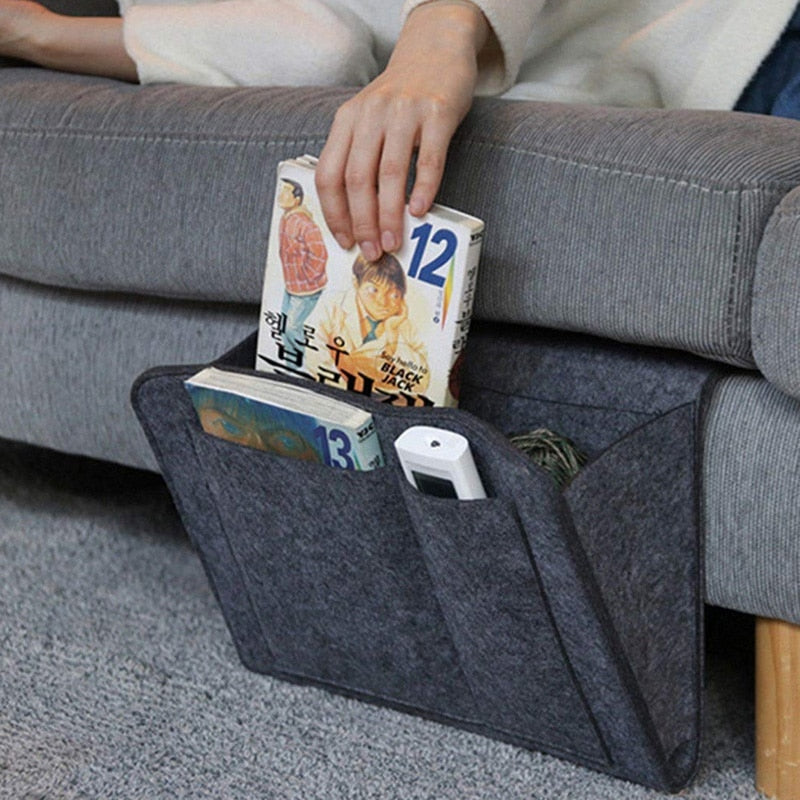Felt bedside storage caddy hanging on the side of a bed