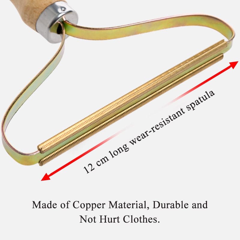 Wood handle lint remover resting on a clean knitted blanket