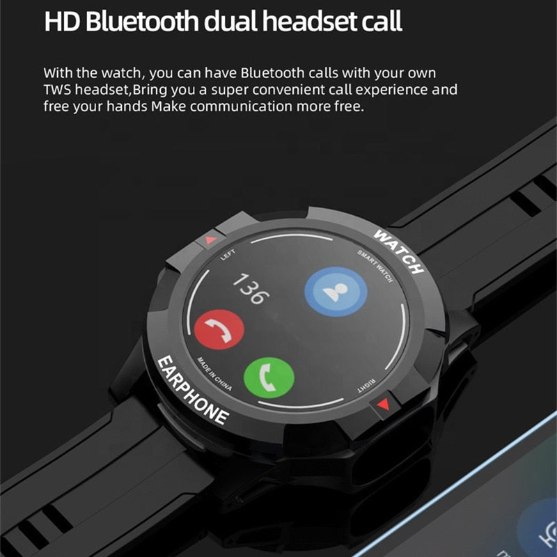 Wireless Bluetooth earbuds resting on a table beside the black smartwatch