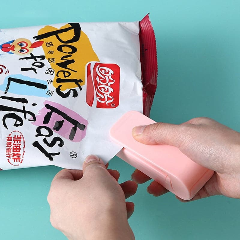 Small, compact bag sealer resting comfortably in the palm of a hand
